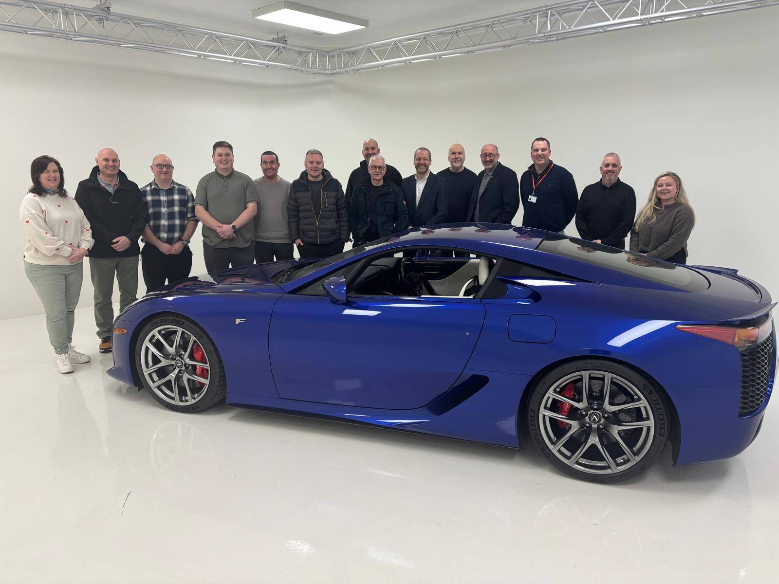 A photograph of the Toyota Lexus training team at Burnaston, pictured alongside a Lexus LFA
