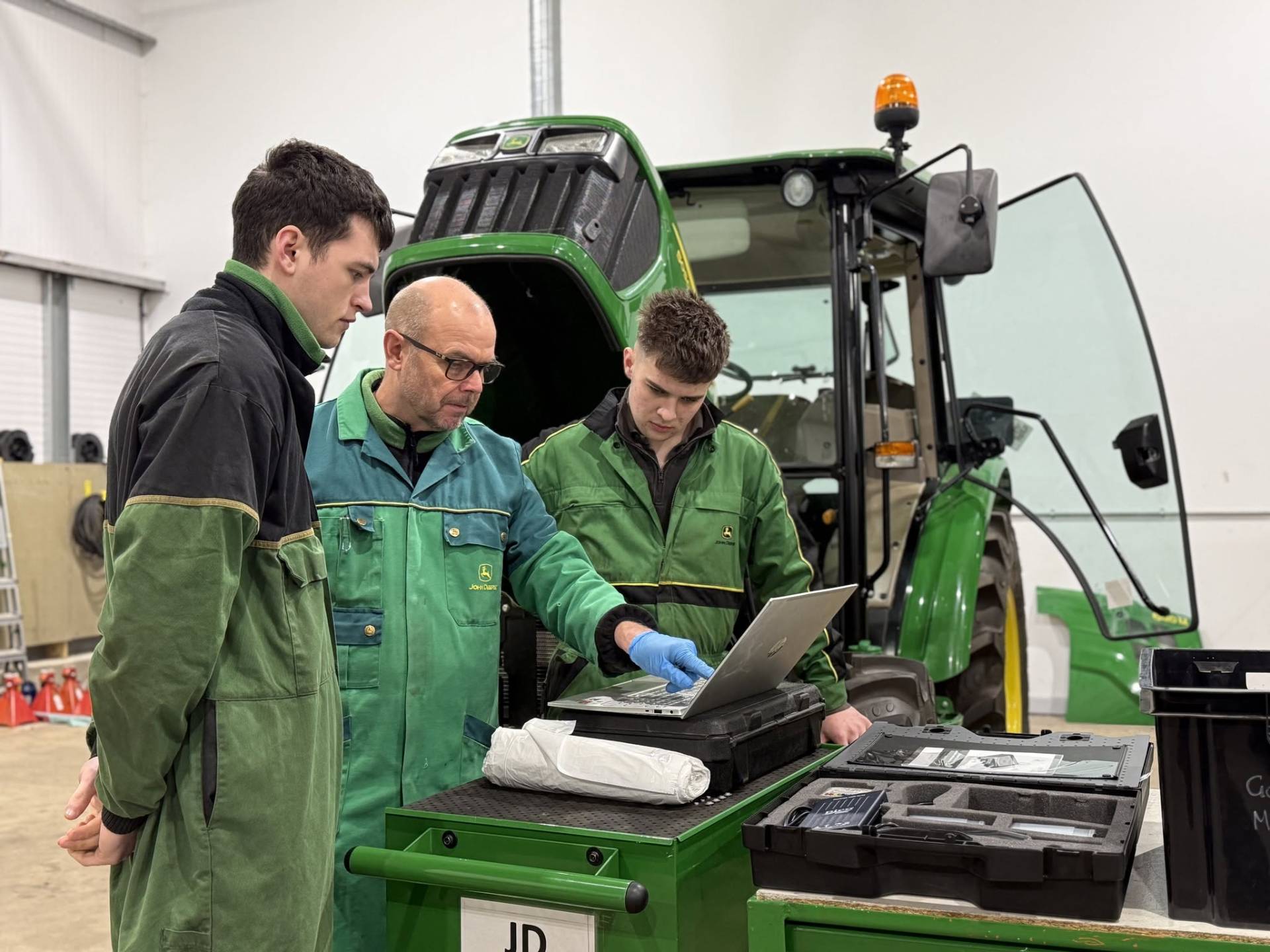 A photograph of John Deere apprentices in the workshop