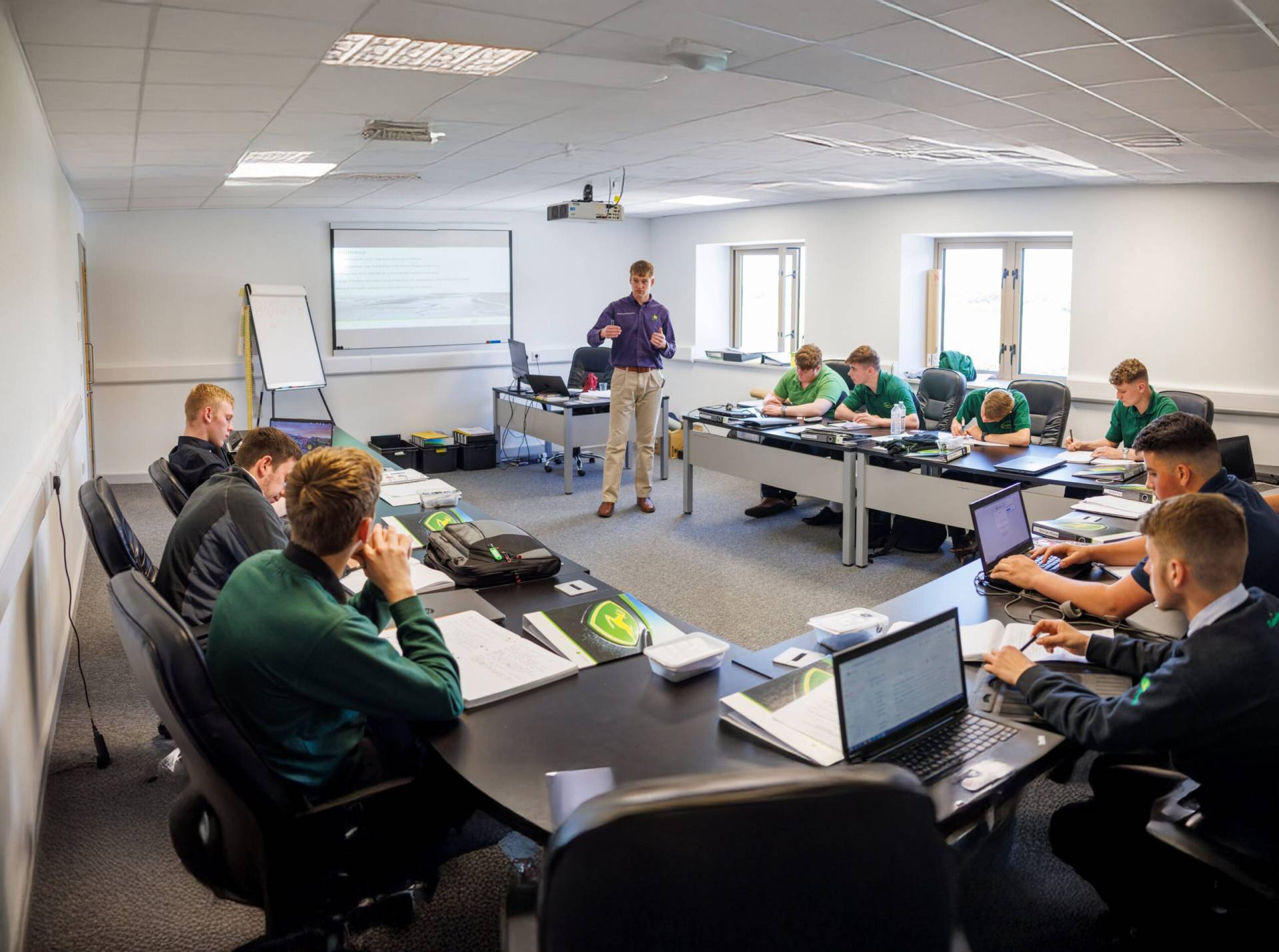 A photograph of a full classroom of John Deere apprentices